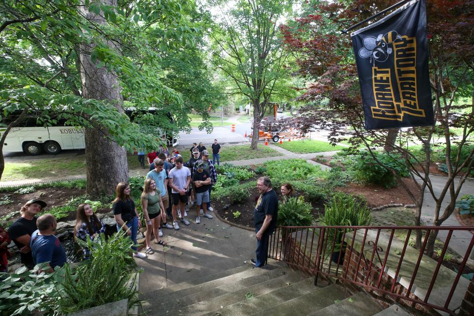 Charlie and Wendy Sommer greet members of the Cadott High School archery team at their home on Eastern Parkway on Saturday, May 13, 2023. For the past 15 years on the Saturday after the Kentucky Derby, the Sommers have renewed an unlikely friendship with Cadott High School archery coach Scott Christenson and his team. Each year a tour bus full of teenagers pulls up in front of their home in the Highlands, blaring its horn as if to say "we're back." The Louisville couple waits for them, dressed in Cadott Hornets gear, and the seniors on the team pose for photos in front of a large sycamore tree in front of their home in the Highlands. For Christenson, this ritual has turned into an outstanding lesson for his students about the importance of building and maintaining friendships.