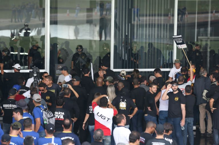 Demonstrators try to force entry into the National Congress building during a protest by police against pension system reform, in Brasilia, on April 18, 2017