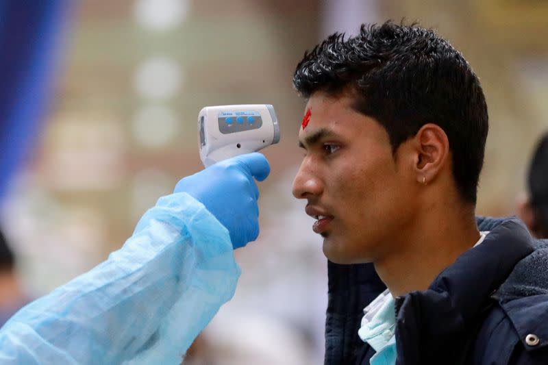 Passengers are checked with a thermal scanner at the Hazrat Shahjalal International Airport as a preventive measure against coronavirus in Dhaka