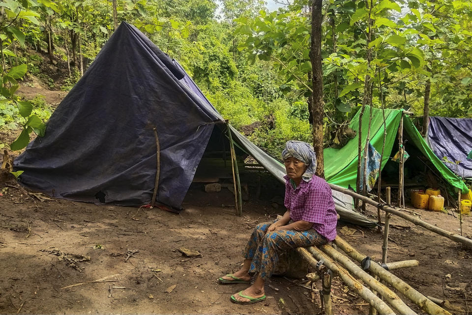 A man sits outside makeshift tents at Pu Phar Village, Demawso Township, Kayah State on Thursday, June 17, 2021. A report on the situation in conflict-affected areas of Myanmar issued this week by the U.N.'s Office for the Coordination of Humanitarian Affairs says around 108,800 people from Kayah State were internally displaced following an escalation of hostilities between the government military and the local Karenni People's Defense Force militia since the coup Feb. 1, 2021. (AP Photo)
