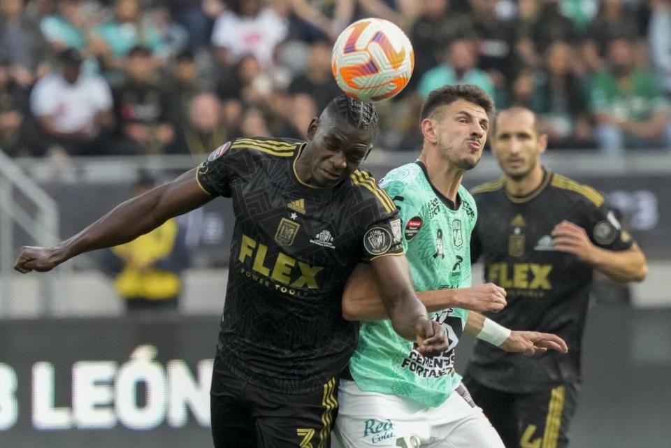 LAFC defender Jesús Murillo, left, challenges León midfielder Lucas Di Yorio.