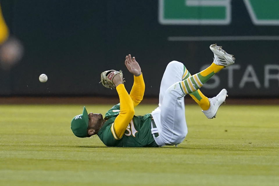Oakland Athletics right fielder Luis Barrera cannot catch a single hit by Texas Rangers' Marcus Semien during the eighth inning of a baseball game in Oakland, Calif., Friday, May 27, 2022. (AP Photo/Jeff Chiu)