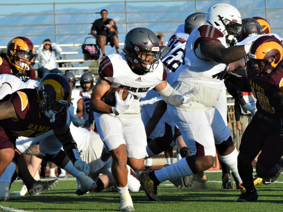 Antelope Valley College's Carlos Hill runs past Victor Valley College's Mac Miller in the first quarter at Ray Moore Stadium on Saturday, Sept. 17, 2022.