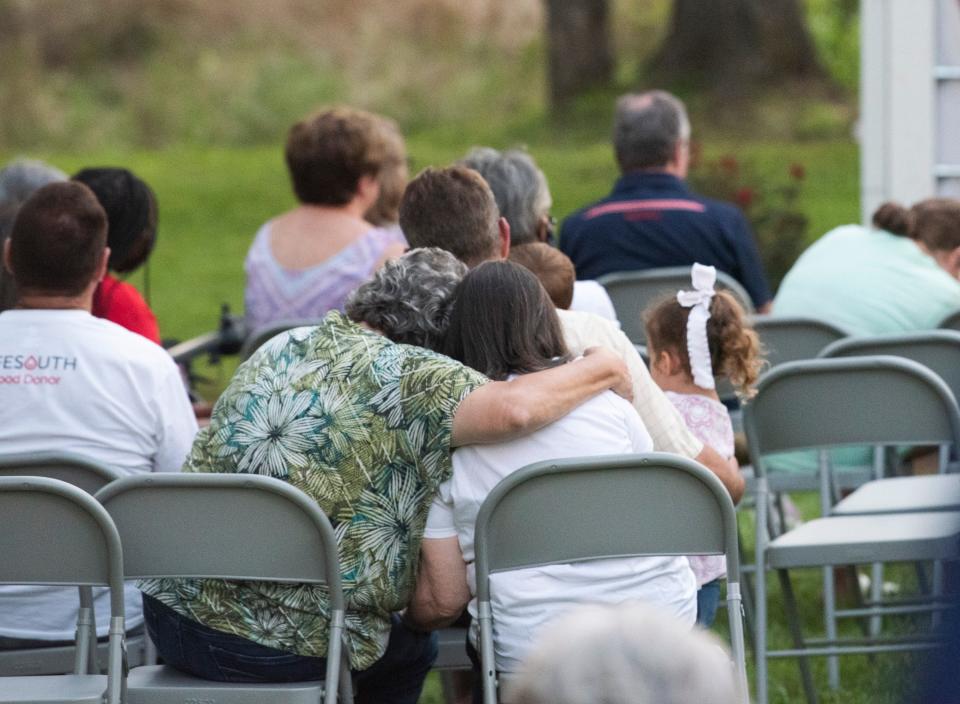 Guest embrace during a community prayer for Tallapoosa County in Dadeville, Ala., on Friday, June 25, 2021. The prayer vigil was held to honor those killed in Saturday's I-65 wreck along with others lost in the last year. 