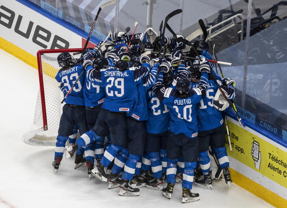 Finland celebrates the win over Sweden after an IIHL World Junior Hockey Championship game, Saturday, Jan. 2, 2021 in Edmonton, Alberta. (Jason Franson/The Canadian Press via AP)