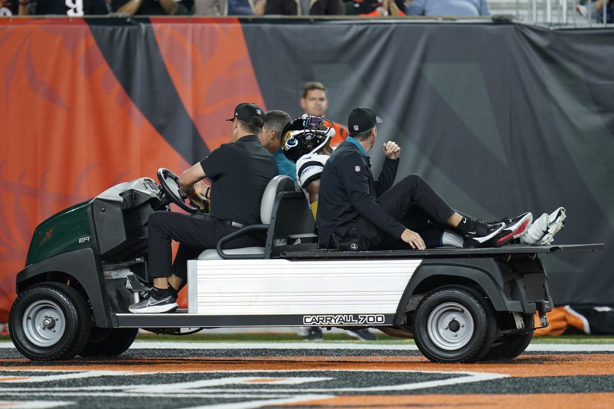 Jacksonville Jaguars' D.J. Chark is carted off the field during the first half of an NFL football game against the Cincinnati Bengals, Thursday, Sept. 30, 2021, in Cincinnati. (AP Photo/Michael Conroy)