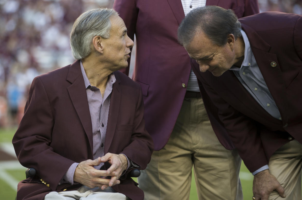 Texas Governor Greg Abbott, left, speaks to Texas A&M Chancellor John Sharp before the start of an NCAA college football game between South Carolina and Texas A&M Saturday, Sept. 30, 2017, in College Station, Texas. (AP Photo/Sam Craft)