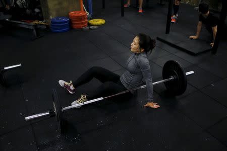 Kim Jin-ah, 31, rests as she takes part in a crossfit class at a gym in Seoul, September 11, 2015. REUTERS/Kim Hong-Ji