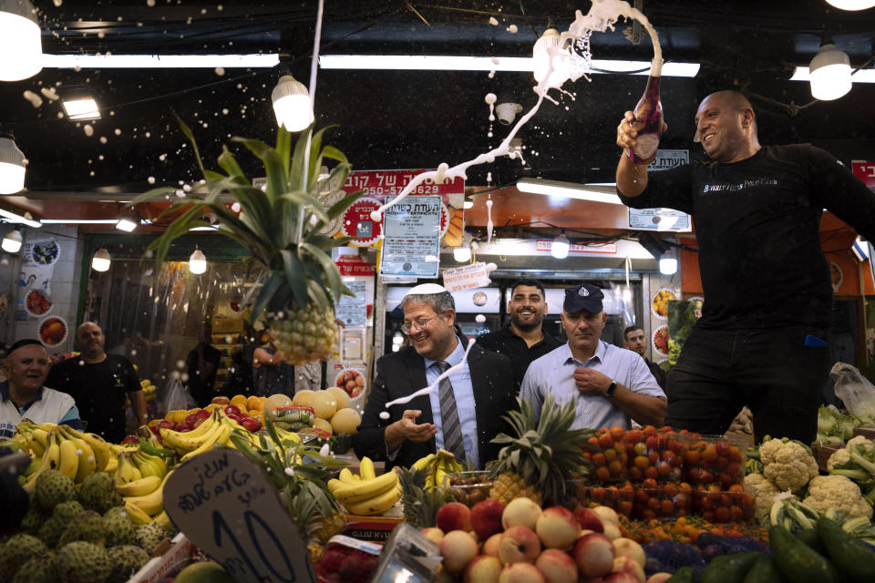 File - Israeli far-right lawmaker and the head of "Jewish Power" party, Itamar Ben-Gvir, center, and his supporters visit at Hatikva Market in Tel Aviv during his campaign ahead of the country's election, Friday, Oct. 21, 2022. Israel is heading into its fifth election in under four years on Nov. 1. (AP Photo/Oded Balilty, File)