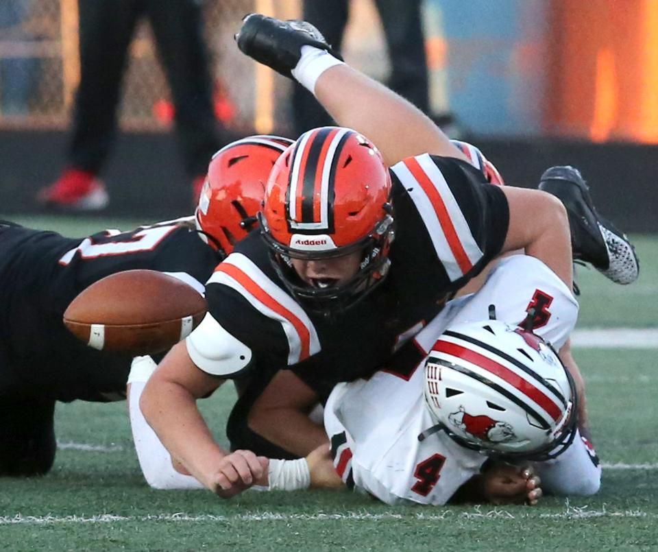 Drew Logan, top, of Hoover recovers the fumble of Amarion Williams, bottom, of McKinley during their game at Hoover on Friday, Sept. 24, 2021.