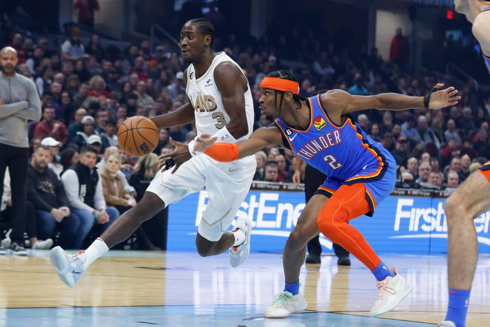 Cavaliers guard Caris LeVert (3) drives against Thunder guard Shai Gilgeous-Alexander (2) during the first half of a 110-102 win Saturday night in Cleveland.