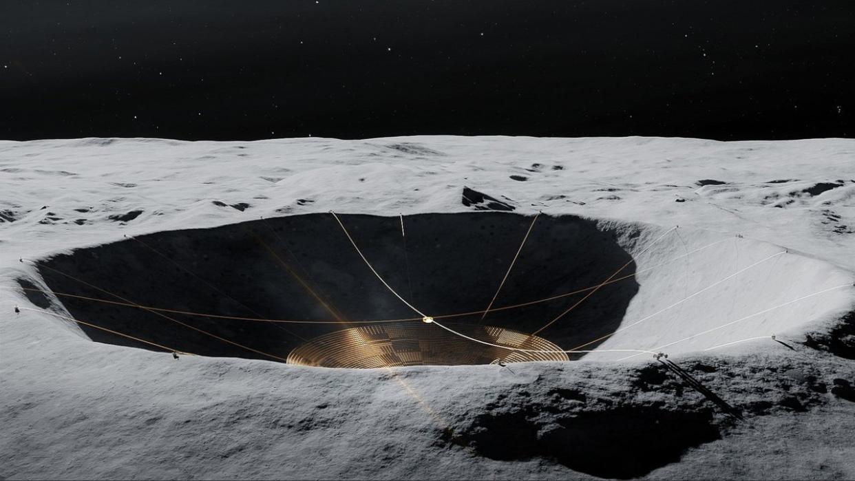  An illustration of a large telescope suspended in side a crater on the moon. 