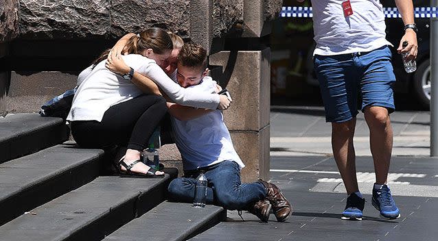 Witnesses console one another at the scene, after a car hit pedestrians in Melbourne's CBD. Photo: AAP