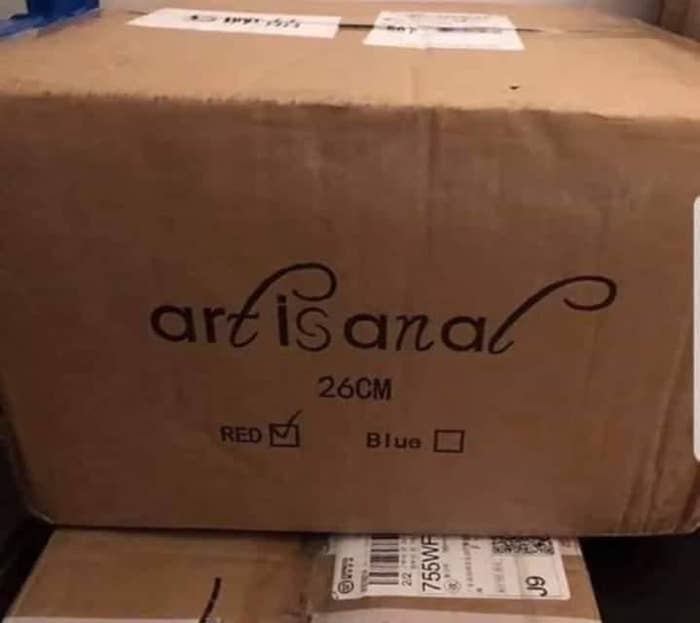 A cardboard box labeled "artisanal," but the curvy T and L make it appear to read "art is anal"