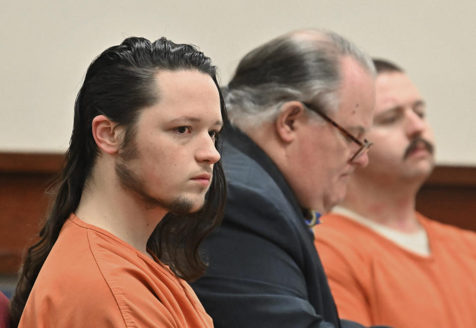 Jacob Kaderli, left, and Michael Helterbrand, right, sit with Helterbrand's attorney Radford Bunker as Kaderli's attorney John Lovell (not pictured) speaks before Floyd County Superior Court Judge Jack Niedrach (not pictured) during their bond hearing at Floyd County Superior Court in Rome, Ga., on Friday, Feb. 14, 2020. Bond was denied Friday for the two Georgia men authorities say are linked to a violent white supremacist group known as The Base. The two men are charged, along with 22-year-old Luke Lane of Silver Creek, of conspiring to kill members of a militant anti-fascist group and participating in a criminal gang. (Hyosub Shin/Atlanta Journal-Constitution via AP)