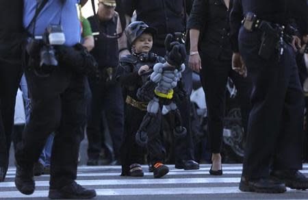 Five-year-old leukemia survivor Miles Scott, dressed as "Batkid" looks at a Batman balloon after a ceremony arranged by the Make- A - Wish Foundation in San Francisco, California November 15, 2013. REUTERS/Stephen Lam