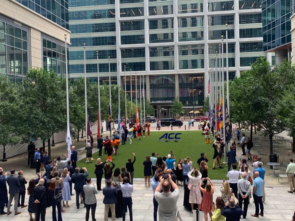 Crowds watch as flags representing all ACC member schools are raised outside the conferences new Charlotte headquarters, at the Bank of America Tower in the Legacy Union complex. Mary Ramsey/The Charlotte Observer