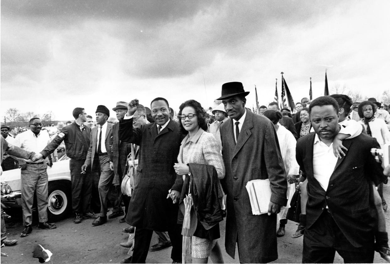 Dr. Martin Luther King Jr., his wife, Coretta Scott King, and Reverend F.D. Reese lead off the final lap to the state capitol at Montgomery, Ala., on March 25, 1965.  (AP file)