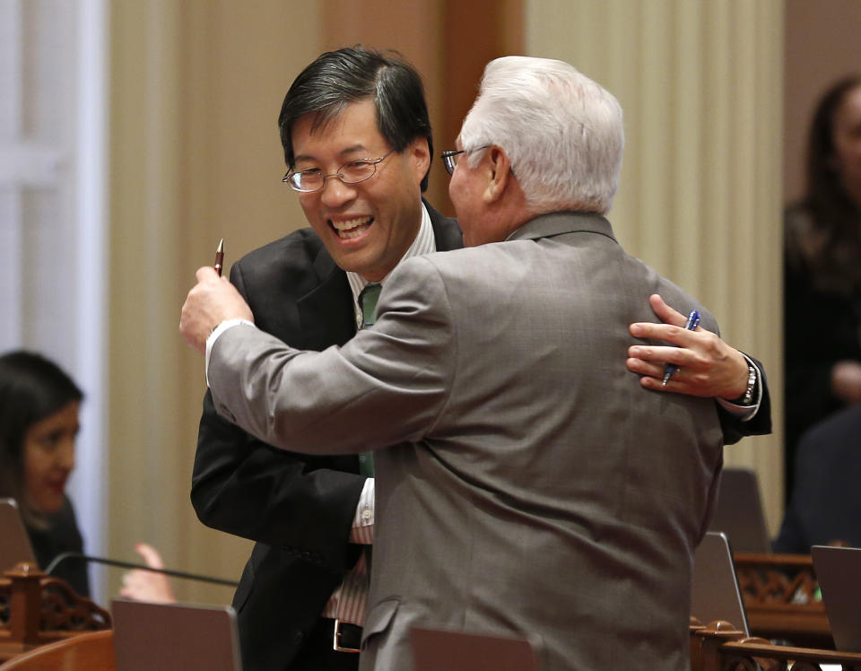 State Sen. Richard Pan, D-Sacramento, left, receives congratulations from Southern California Democratic state Sen. Bob Archuleta, right, after his measure to toughen the rules for vaccination exemptions was approve by the Senate, Wednesday, May 22, 2019, in Sacramento, Calif. The bill, SB276, gives state public health officials instead of local doctors the power to decide which children can skip their shots before attending school. (AP Photo/Rich Pedroncelli)