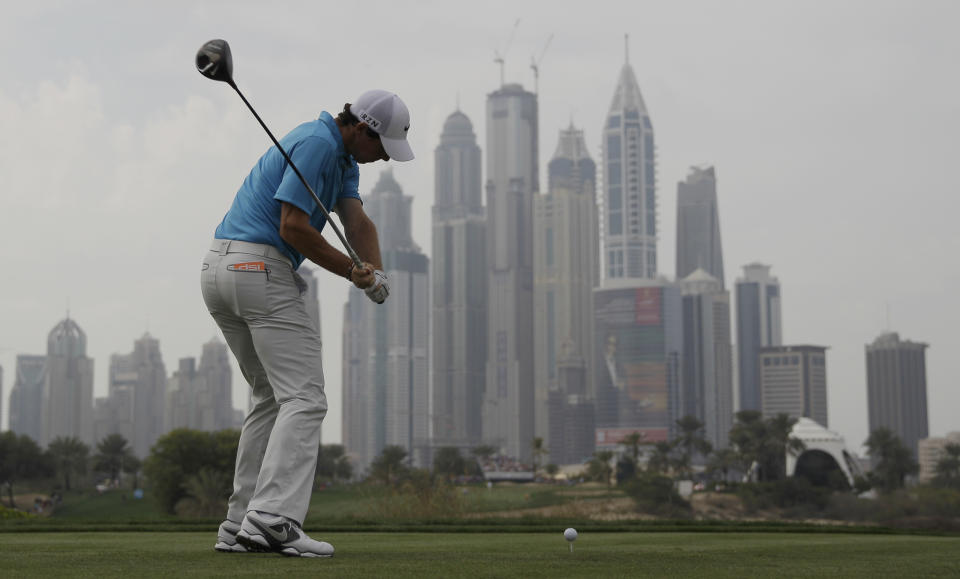 Rory McIlroy of Northern Ireland tees off on the 8th hole during the third round of the Dubai Desert Classic golf tournament in Dubai, United Arab Emirates, Saturday, Feb. 1, 2014. (AP Photo/Kamran Jebreili)