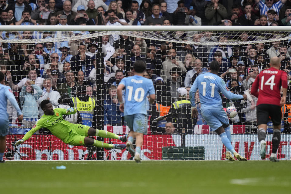 Manchester United's goalkeeper Andre Onana dives but fails to save the goal from Coventry City's Haji Amir Wright, second right, during the English FA Cup semifinal soccer match between Coventry City and Manchester United at Wembley stadium in London, Sunday, April 21, 2024. (AP Photo/Alastair Grant)