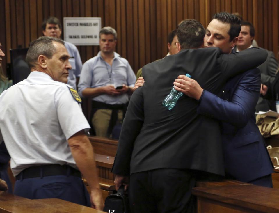 Olympic and Paralympic track star Oscar Pistorius hugs his brother Carl Pistorius during his trial at the North Gauteng High Court in Pretoria