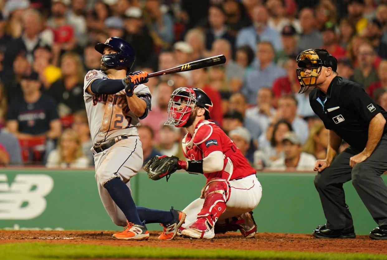 Astros second baseman Jose Altuve hits a triple to drive in two runs against the Red Sox in Monday's game. Altuve hit for the cycle against Boston.