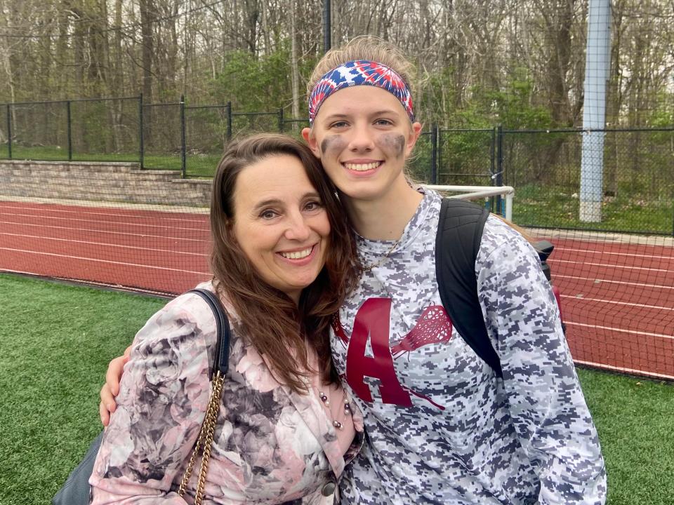 Louise Lynch, the mother of former Our Lady of Lourdes athlete Madison Lynch-Dingee, poses alongside Arlington's Talia Berardo after a May 3, 2022 girls lacrosse game. Berardo scored in honor of Madison, a close friend who died in December.