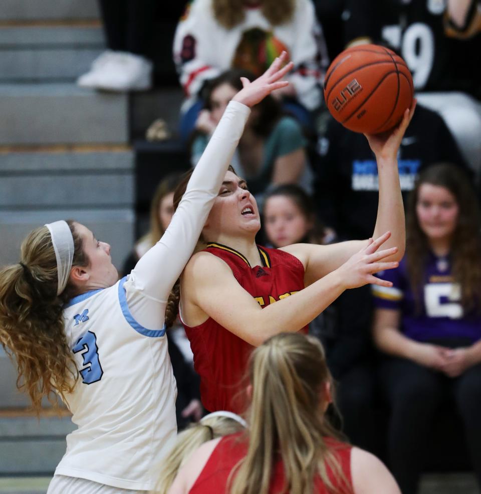 Mercy's Mary Smith (3) made contact with Bullitt East's Emma Egan (10) as she went in for a layup during their game at Mercy Academy in Louisville, Ky. on Jan. 20, 2022.