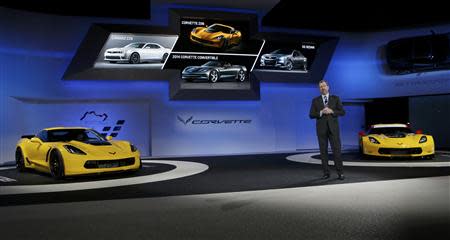 Daniel Ammann, President of GM, speaks between the Chevrolet Corvette Stingray ZO6 street version (L) and the racing version during the press preview day of the North American International Auto Show in Detroit, Michigan January 13, 2014. REUTERS/Rebecca Cook