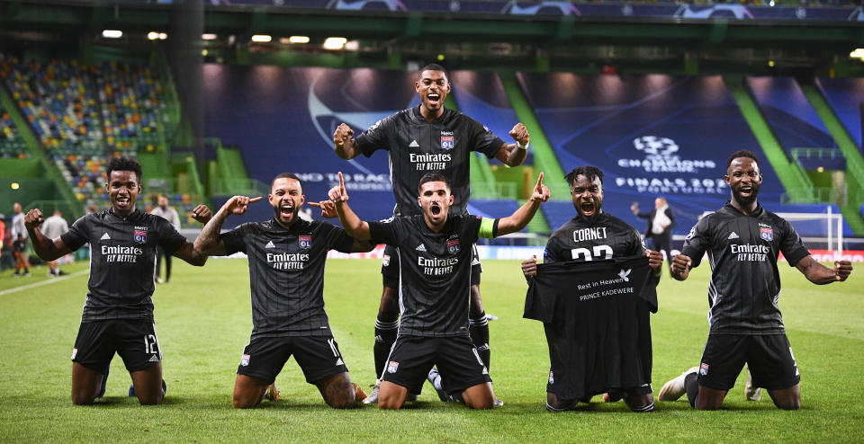 Lyon players celebrate after winning the Champions League quarterfinal match against Manchester City at the Jose Alvalade stadium in Lisbon, Portugal, Saturday, Aug. 15, 2020. (Franck Fife/Pool Photo via AP)