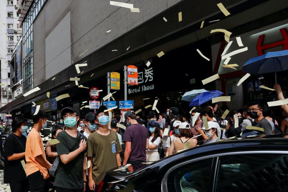 protesters throw paper money.JPG