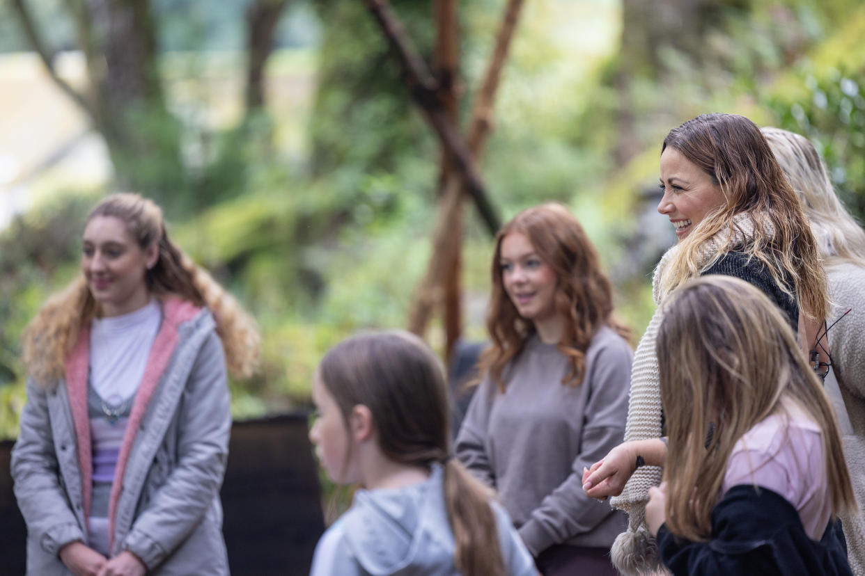 Members of the choir standing together in the woods