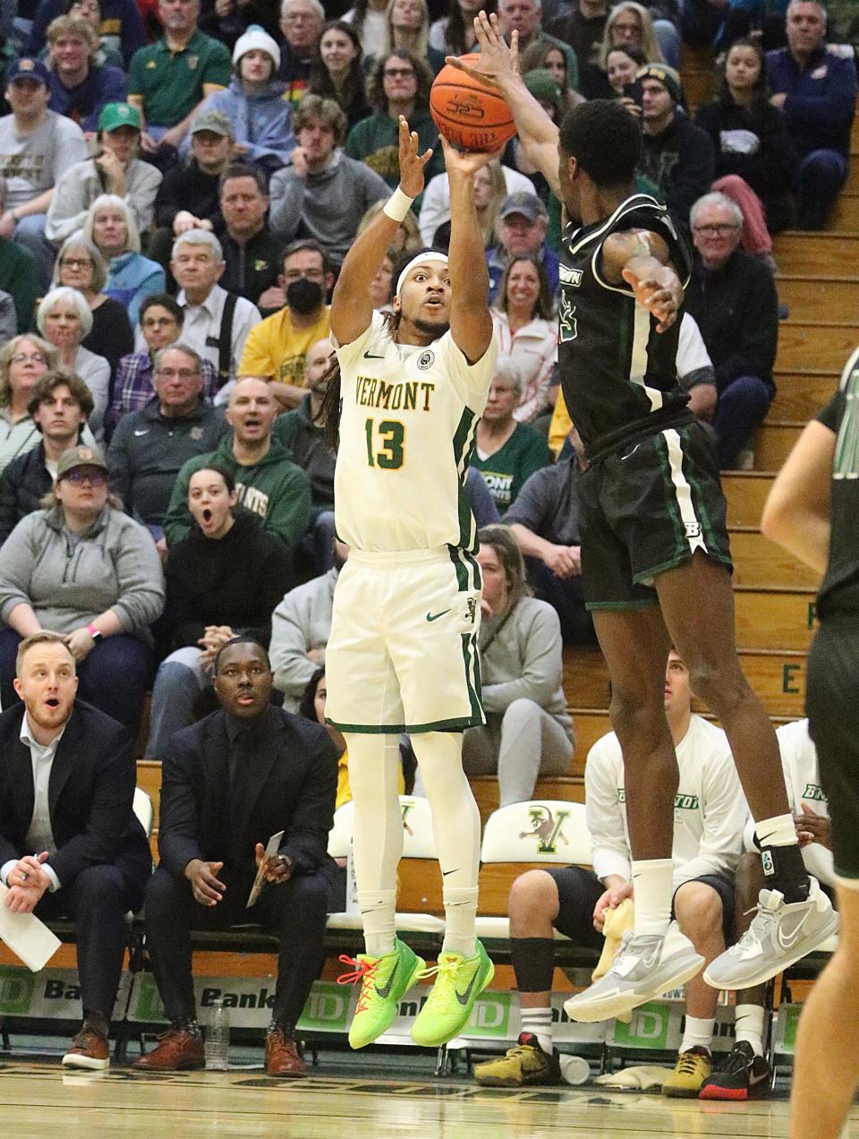 Vermont's Dylan Penn drains a 3-point shot over the outstretched arms of of Binghamton's Tavelon White during the Catamounts 79-57 win over the Bearcats in the America East semifinals on Tuesday night at Patrick Gym.
