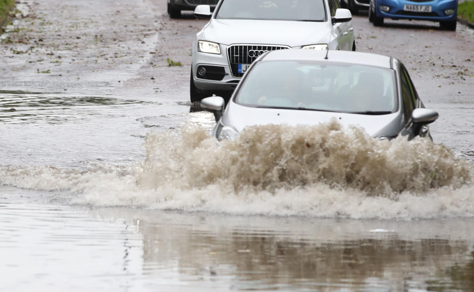 Car going through a flooded street in Whitley Bay in Northumberland. A slow-moving band of heavy rain set to drench parts of the UK has triggered weather warnings and flood alerts.