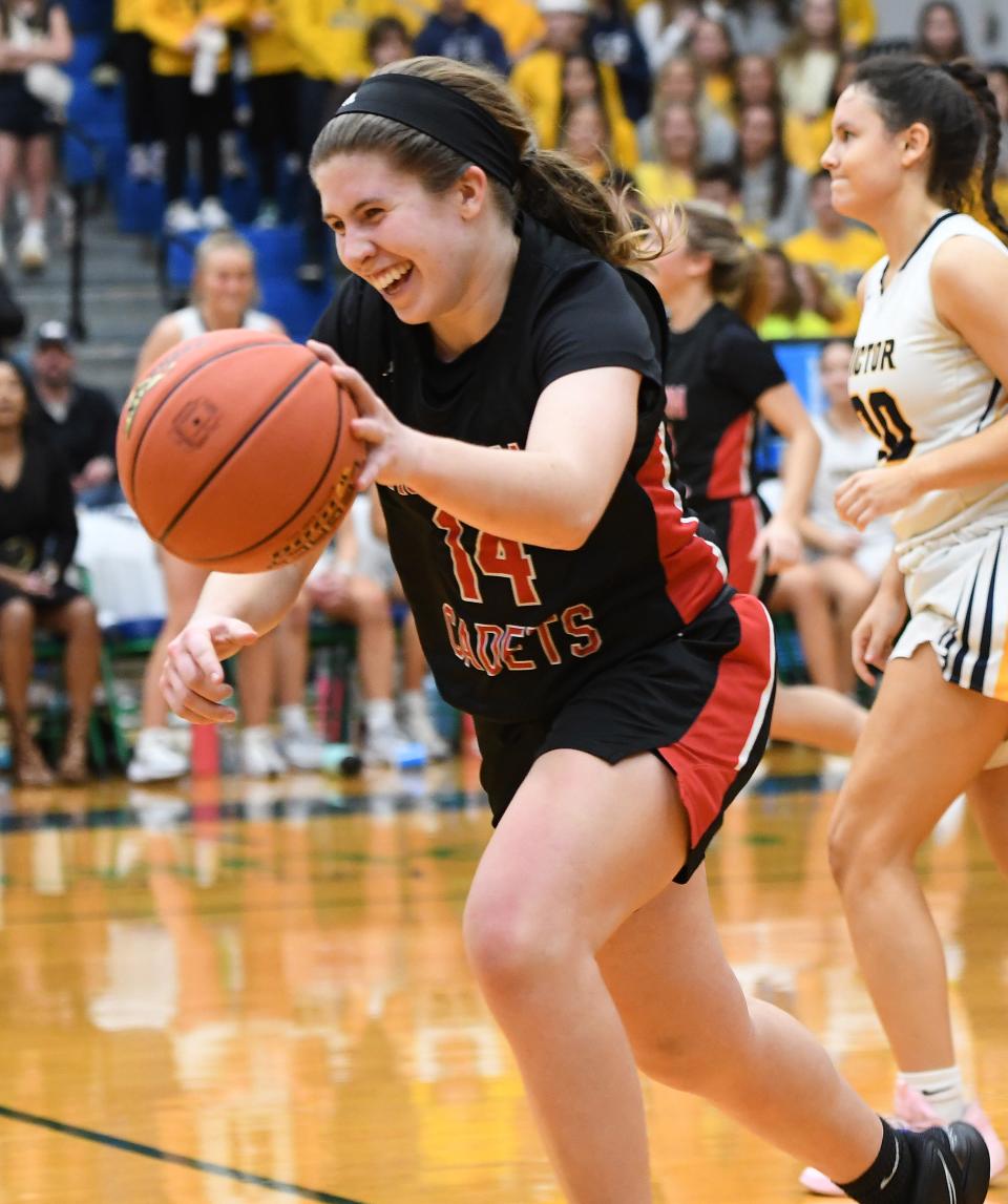 Mallory Heise is all smiles as she dribbles out the final moments of the clock as Hilton defeated Victor 38-33 on Saturday night,.