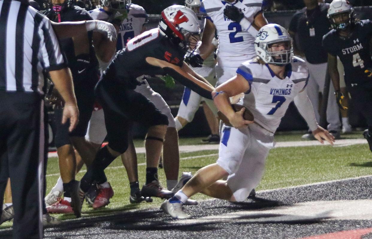 Lakeland Christian quarterback Parker St. John fights his way into the end zone for a touchdown in the third quarter against Victory Christian.