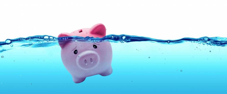 Piggy bank drowning in debt - savings to risk