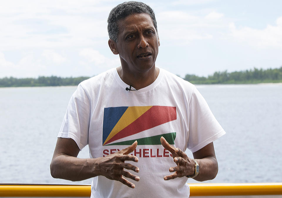 Seychelles President Danny Faure speaks during an interview with the Associated Press, on the island of Desroches, Seychelles on Sunday April 14, 2019. In a striking speech delivered from deep below the ocean's surface, the Seychelles president on Sunday made a global plea for stronger protection of the "beating blue heart of our planet." President Danny Faure's call for action, the first-ever live speech from an underwater submersible, came from one of the many island nations threatened by global warming.(AP Photo/Steve Barker)