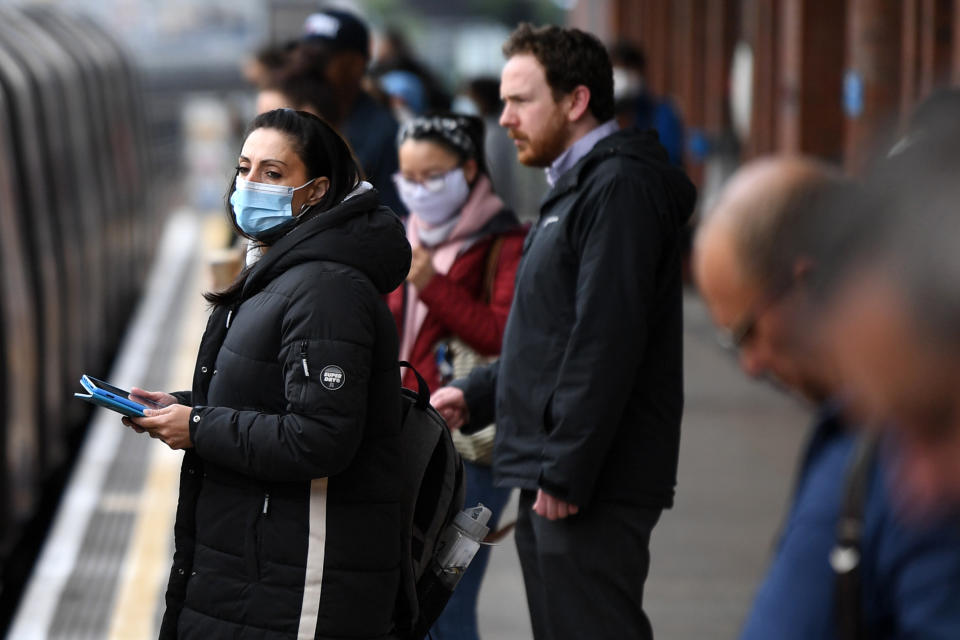 Commuters wearing PPE (personal protective equipment), including a face mask as a precautionary measure against COVID-19, travel in the morning rush hour on TfL (Transport for London) underground trains from West Ham towards central London on May 13, 2020, as people start to return to work after COVID-19 lockdown restrictions were eased. - Britain's economy shrank two percent in the first three months of the year, rocked by the fallout from the coronavirus pandemic, official data showed Wednesday, with analysts predicting even worse to come. Prime Minister Boris Johnson began this week to relax some of lockdown measures in order to help the economy, despite the rising death toll, but he has also stressed that great caution is needed. (Photo by DANIEL LEAL-OLIVAS / AFP) (Photo by DANIEL LEAL-OLIVAS/AFP via Getty Images)