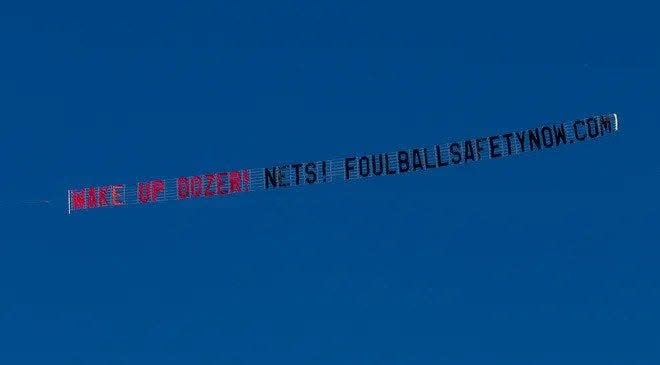 An airplane hired by baseball safety advocacy group Foul Ball Safety Now goes over Dozer Park with a message for Peoria Chiefs fans during a Midwest League game.