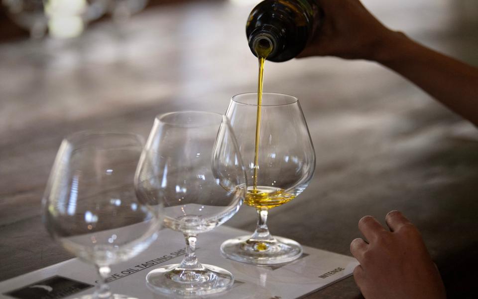 The Rustica olive oil is poured into glasses for a tasting at the Rustica Olive Estate