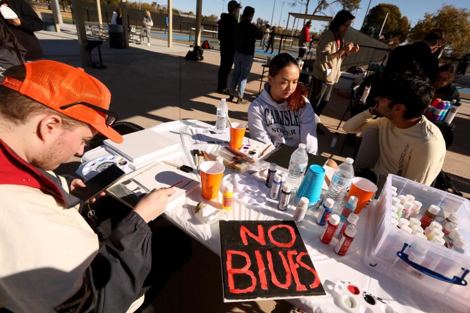 UNLV student Mina Hickey, 19, center, and other students paint to avoid