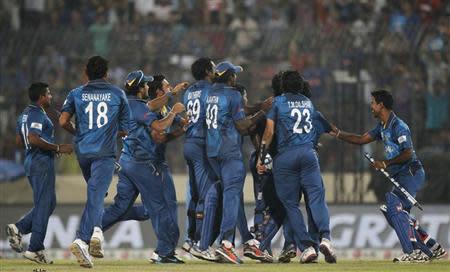 Sri Lanka's players celebrate winning the ICC Twenty20 World Cup cricket title after beating India at the Sher-E-Bangla National Cricket Stadium in Dhaka April 6, 2014. REUTERS/Andrew Biraj