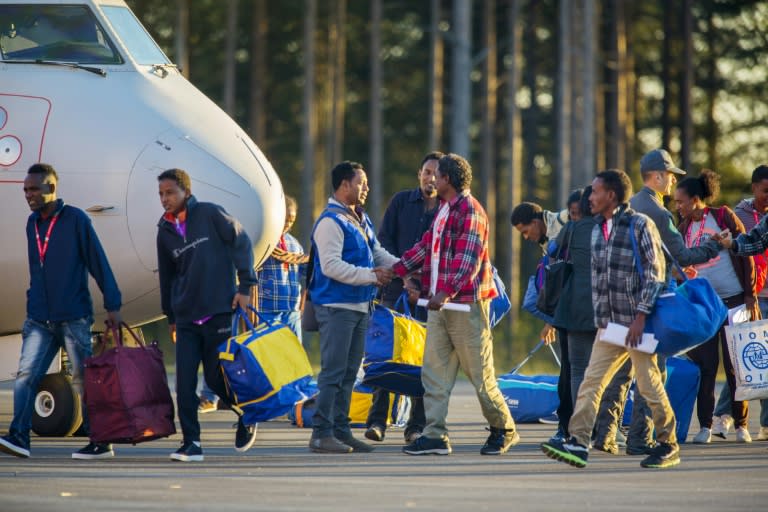 Eritrean asylum seekers arrive at Lulea Airport, Kallax northern Sweden from Rome's Ciampino airport on October 9, 2015