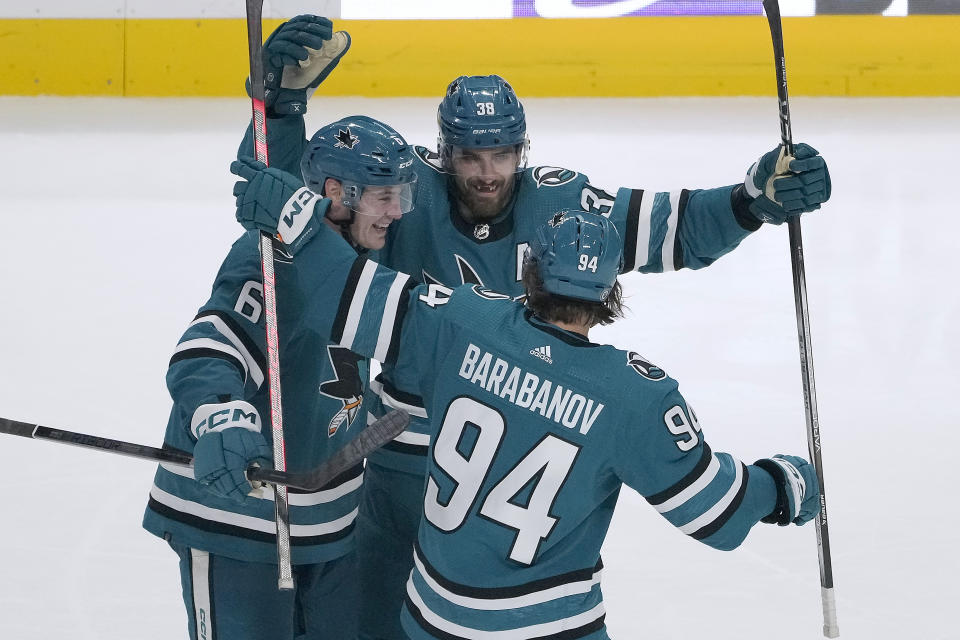 San Jose Sharks' Alexander Barabanov (94) celebrates with Ty Emberson (6) and Mario Ferraro (38) after scoring a goal against the Detroit Red Wings during the third period of an NHL hockey game Tuesday, Jan. 2, 2024, in San Jose, Calif. (AP Photo/Tony Avelar)