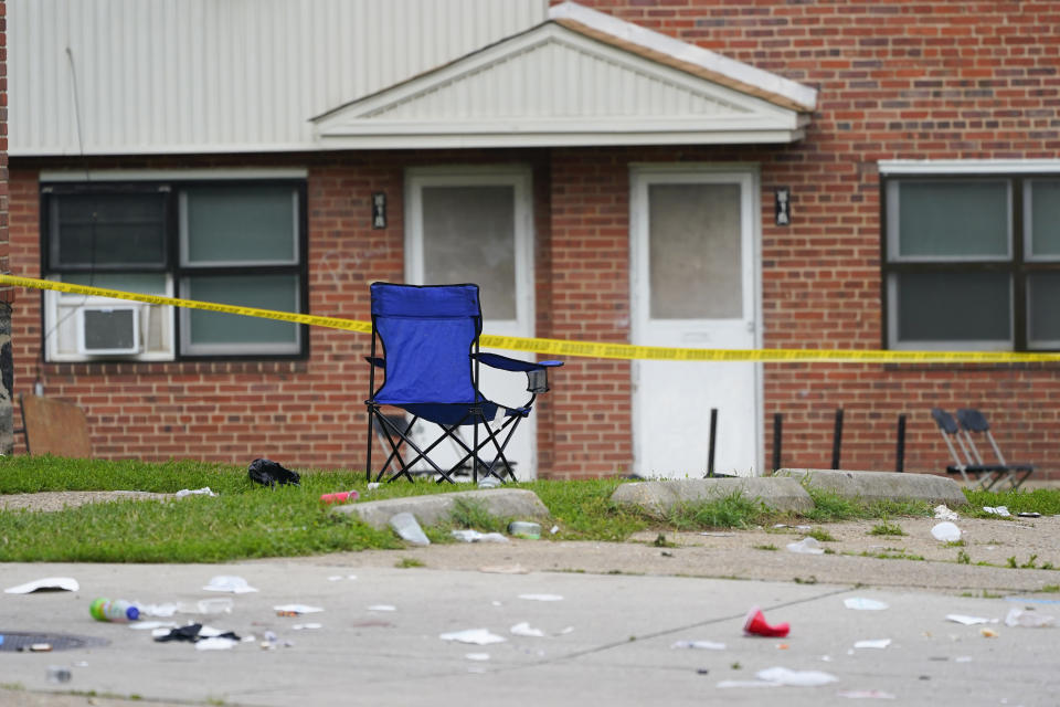 CAPTION CORRECTION: CORRECTS DATE: FILE - A chair remains upright in the area of a mass shooting incident in the Southern District of Baltimore, Sunday, July 2, 2023. Police announced Thursday, Aug. 17, 2023, that a teenager has been arrested in the shooting that left two people dead and 28 others injured earlier this summer. (AP Photo/Julio Cortez, File)