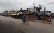 A man rides a cycle on a deserted street during fresh lockdown in Prayagraj, India, Saturday, July 11, 2020. In just three weeks, India went from the world’s sixth worst-affected country by the coronavirus to the third, according to a tally by Johns Hopkins University. India's fragile health system was bolstered during a stringent monthslong lockdown but could still be overwhelmed by an exponential rise in infections. (AP Photo/Rajesh Kumar Singh)