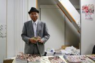 The President of the Stardom female professional wrestling promotion Hiroshi "Rossy" Ogawa sells brochures before the start of a wrestling show at Korakuen Hall in Tokyo, Japan, December 23, 2015. REUTERS/Thomas Peter