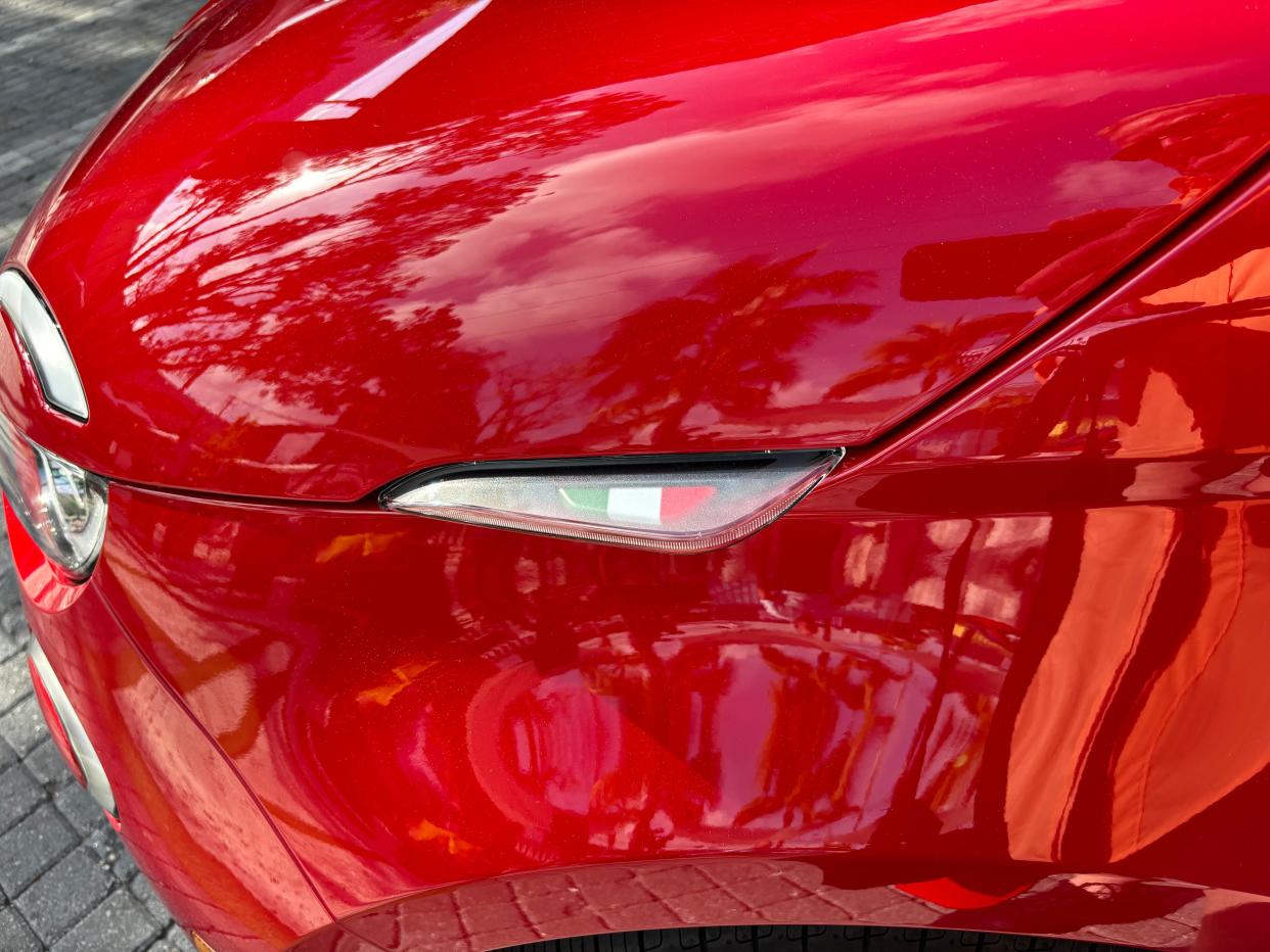 A little Italian flag adorns the 2024 Fiat 500e mini-compact electric vehicle's front fenders.